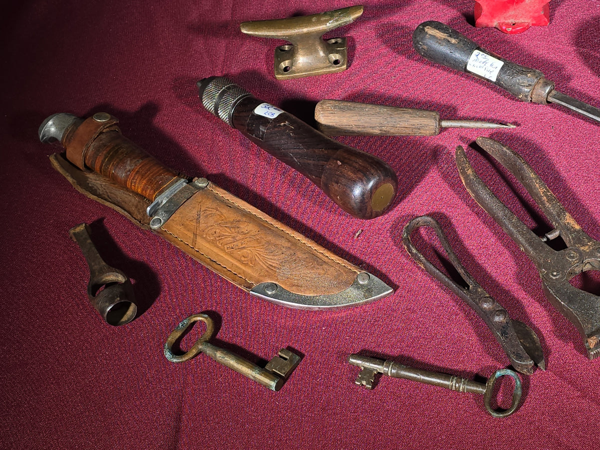 Grouping of Antique and Vintage Small Hand Tools and Hardware including Hunting Knife with Leather Sheath, Miniature Anvil, Dock Cleat, Skeleton Keys, and Awls