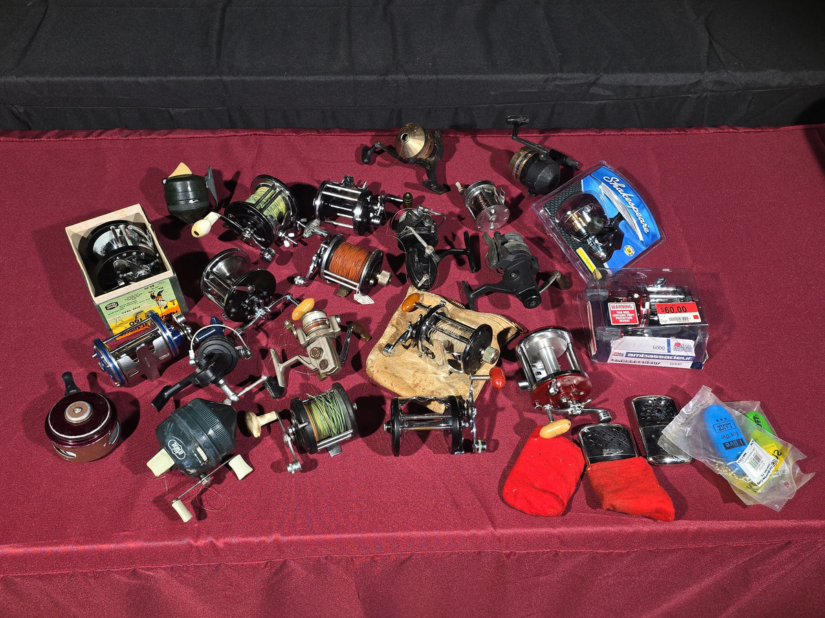 Grouping of 20+ Vintage and Modern Fishing Reels Including Penn Long Beach No. 60, Penn Jigmaster No. 500, Penn No. 155, Penn Hi-Surfer No. 160, Olympic Dolphin 612, Ocean City 113, South Bend Automatic, Abu Garcia Ambassadeur 6000, and More