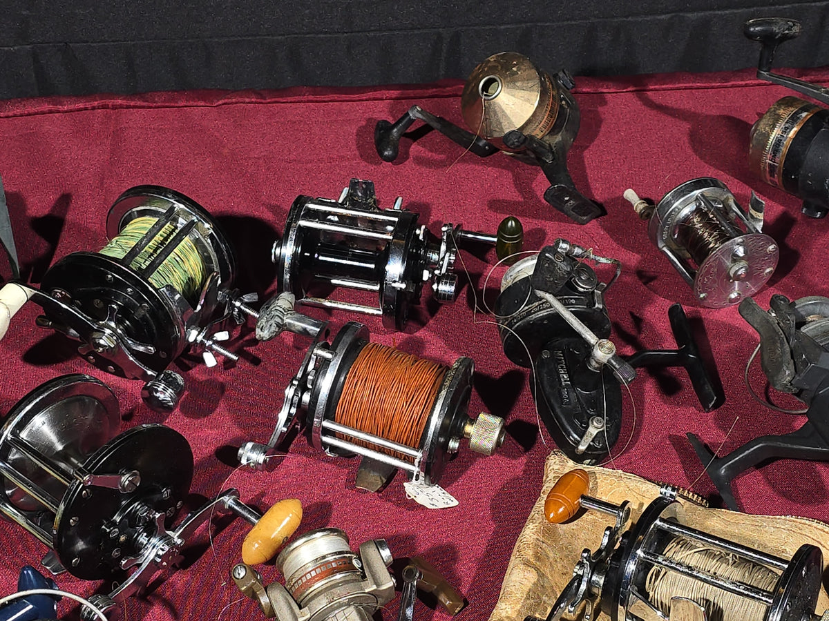 Grouping of 20+ Vintage and Modern Fishing Reels Including Penn Long Beach No. 60, Penn Jigmaster No. 500, Penn No. 155, Penn Hi-Surfer No. 160, Olympic Dolphin 612, Ocean City 113, South Bend Automatic, Abu Garcia Ambassadeur 6000, and More