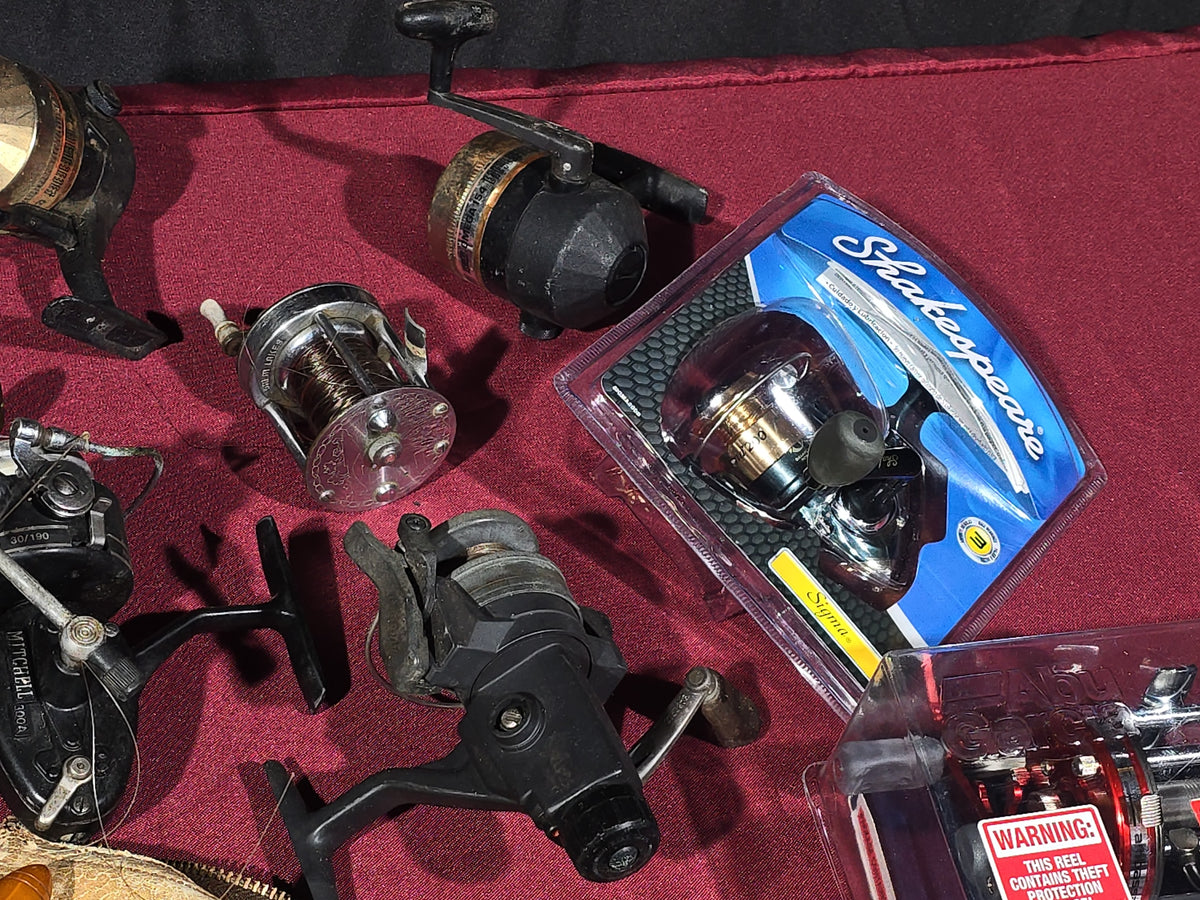 Grouping of 20+ Vintage and Modern Fishing Reels Including Penn Long Beach No. 60, Penn Jigmaster No. 500, Penn No. 155, Penn Hi-Surfer No. 160, Olympic Dolphin 612, Ocean City 113, South Bend Automatic, Abu Garcia Ambassadeur 6000, and More