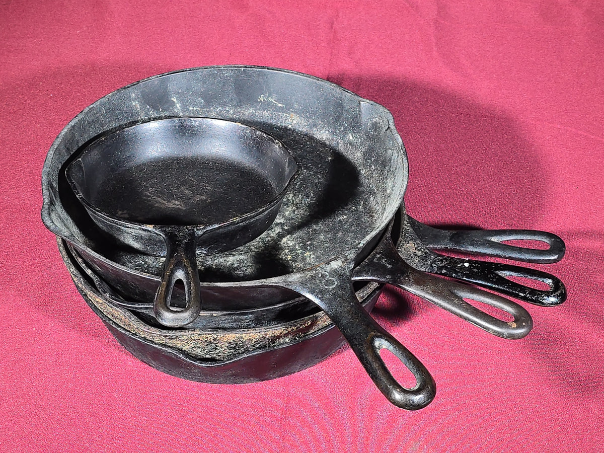 Grouping of Five Antique and Vintage Cast Iron Skillets including Griswold No. 7, Wagner Ware No. 8, and Wapak No. 8