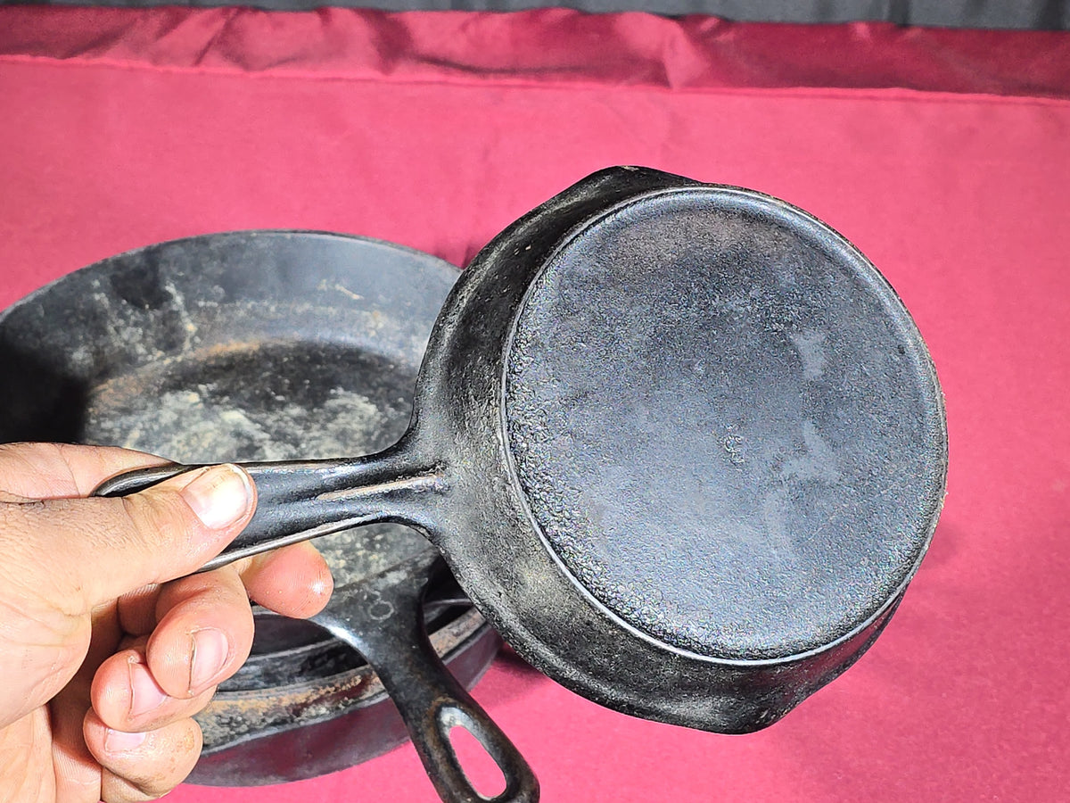 Grouping of Five Antique and Vintage Cast Iron Skillets including Griswold No. 7, Wagner Ware No. 8, and Wapak No. 8
