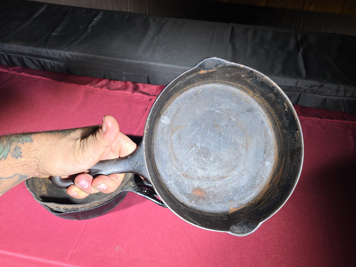 Grouping of Five Antique and Vintage Cast Iron Skillets including Griswold No. 7, Wagner Ware No. 8, and Wapak No. 8