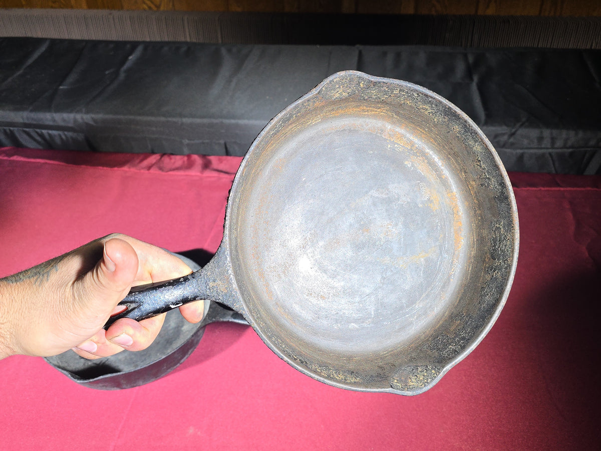 Grouping of Five Antique and Vintage Cast Iron Skillets including Griswold No. 7, Wagner Ware No. 8, and Wapak No. 8