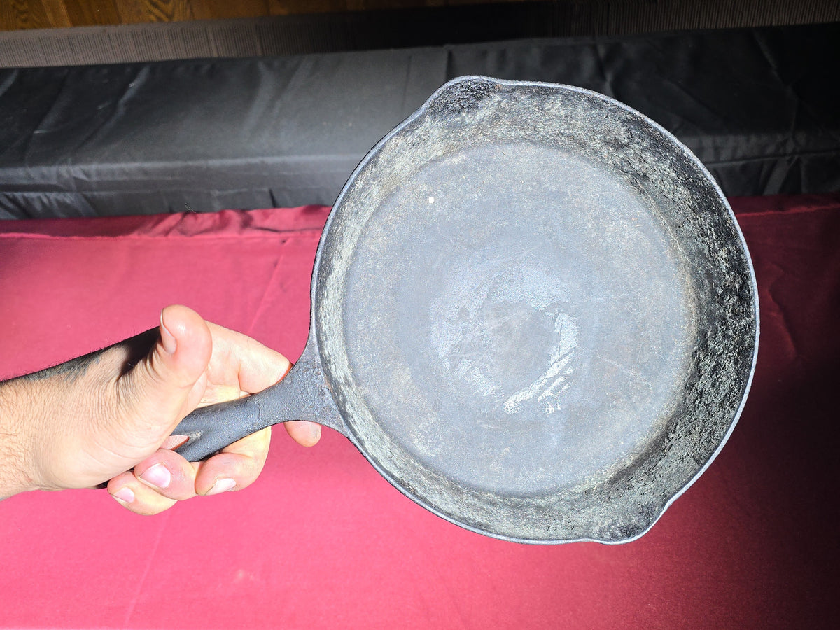 Grouping of Five Antique and Vintage Cast Iron Skillets including Griswold No. 7, Wagner Ware No. 8, and Wapak No. 8