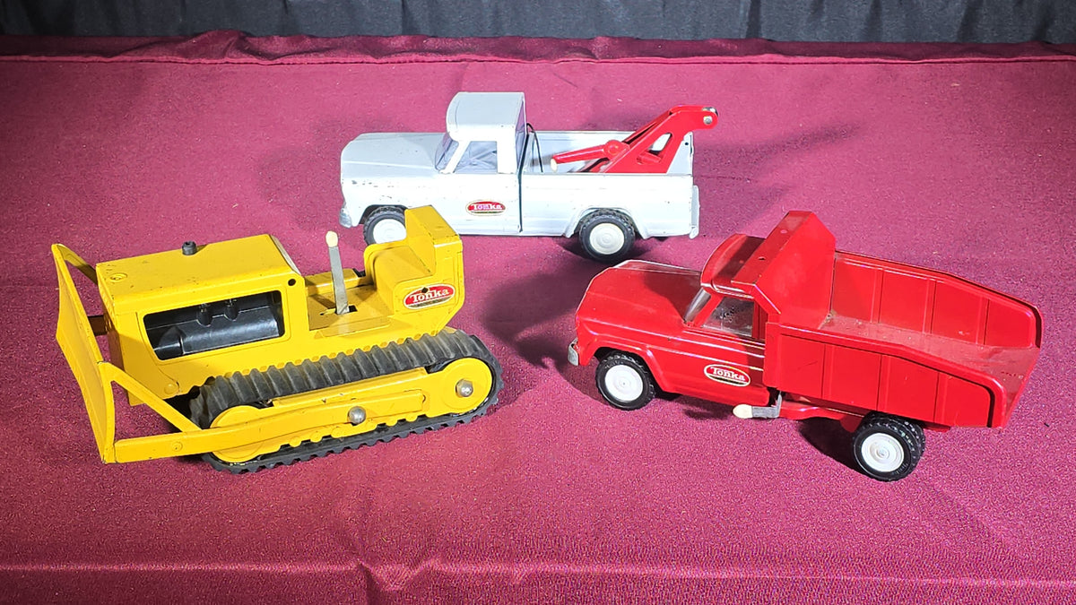 Trio of Vintage Pressed Steel Tonka Toys including Bulldozer, Dump Truck, and Tow Truck