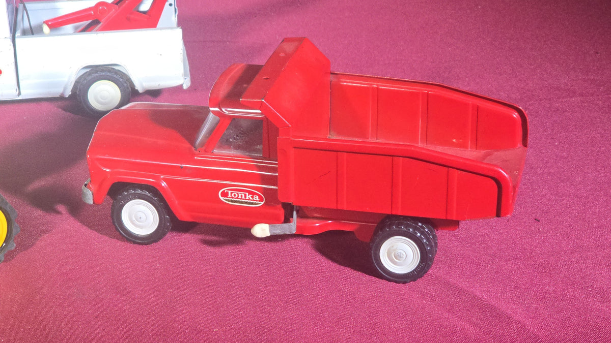 Trio of Vintage Pressed Steel Tonka Toys including Bulldozer, Dump Truck, and Tow Truck