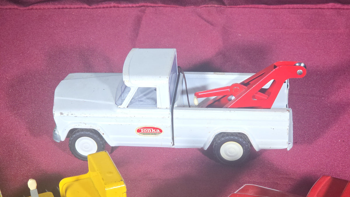 Trio of Vintage Pressed Steel Tonka Toys including Bulldozer, Dump Truck, and Tow Truck