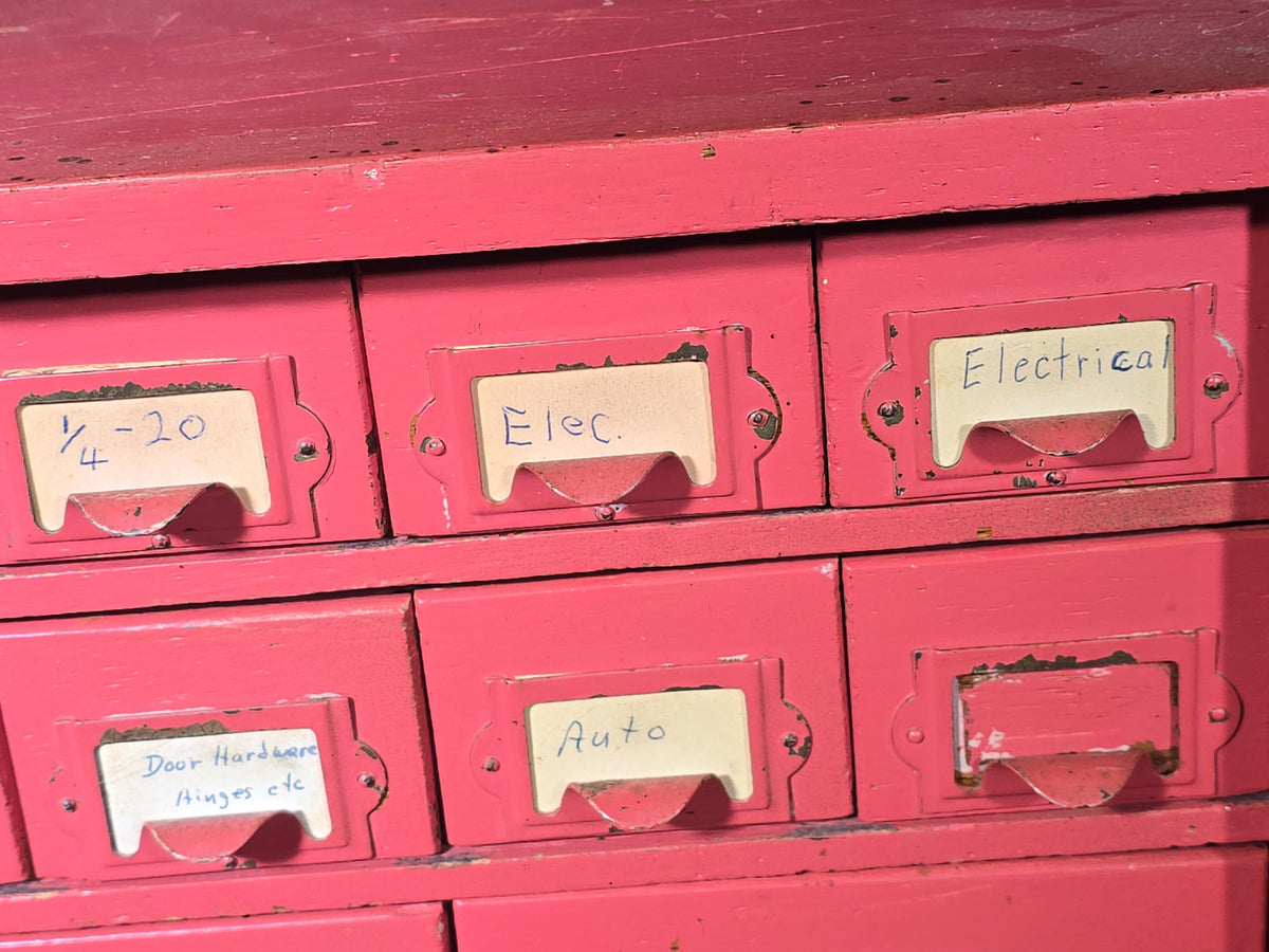 Vintage Pink-Painted Wooden Parts Cabinet with 18 Metal Drawers and Handwritten Labels