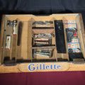 Lot 205 - Vintage Gillette Advertising Wooden Display Case with Assorted Smalls Including Mickey Mouse Patch, Pal Razor Blades, Dennis the Menace Flashlights, and Chevrolet Emblem, 18-1/4" L x 14" W