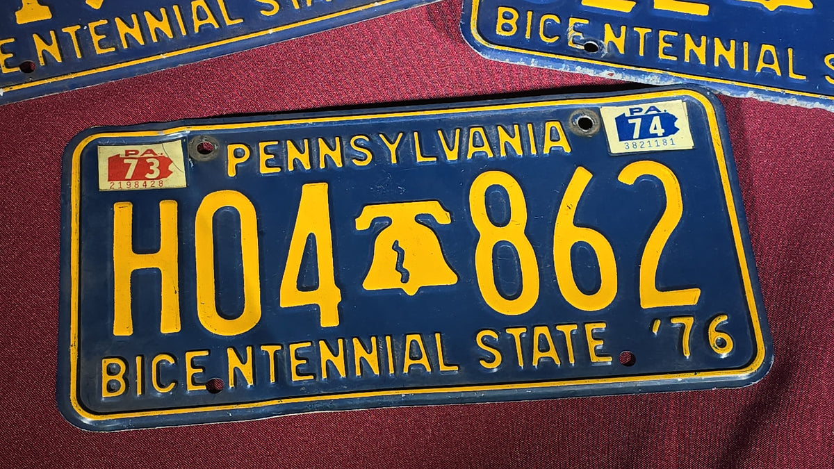 Grouping of Seven Vintage Pennsylvania License Plates including Bicentennial and Dealer Plates, 1970s–1980s