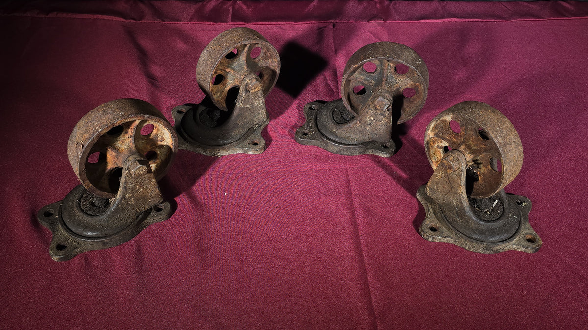 Grouping of Four Antique Cast Iron Industrial Caster Wheels, Manufactured by Service Caster Co., Albion, Michigan