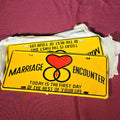 Lot 090 - Grouping of Five Vintage "Marriage Encounter" Novelty License Plates