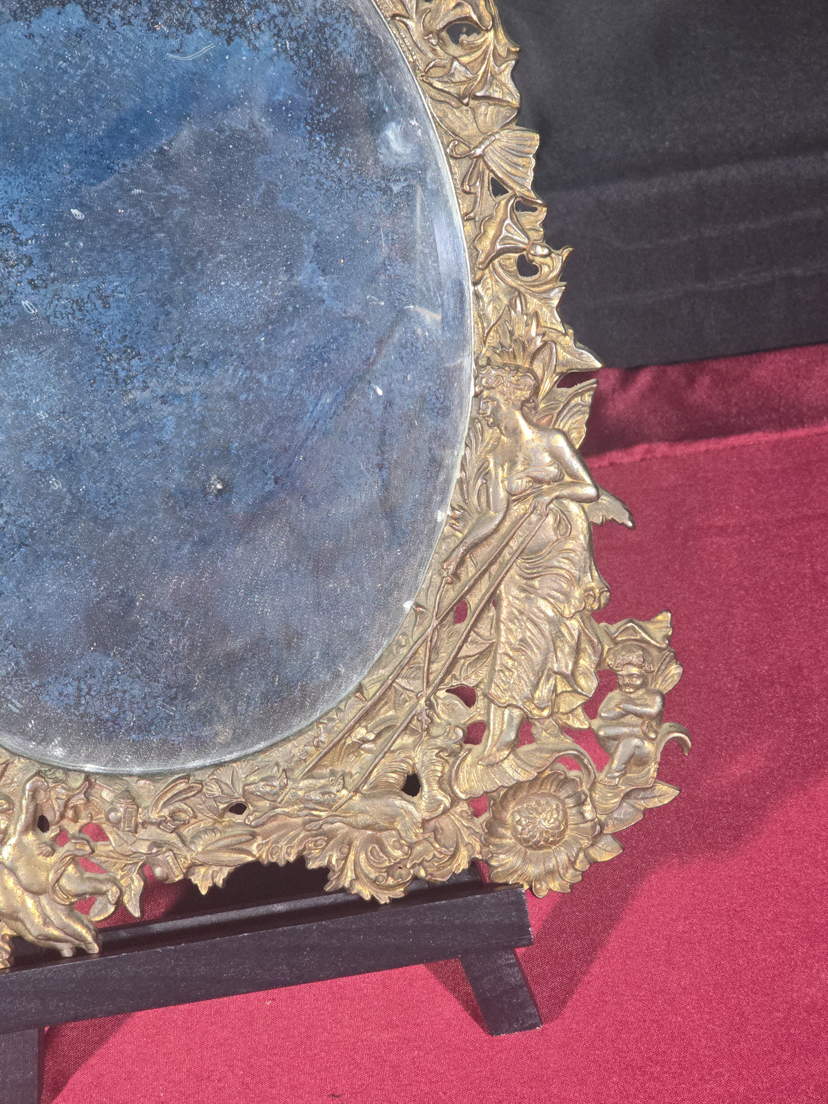 Antique Cast Brass Oval Mirror with Figural Cherub and Floral Surround