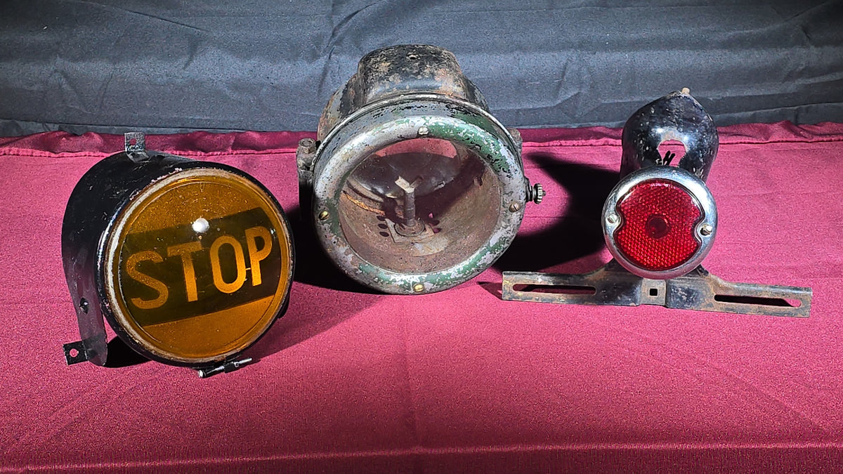 Grouping of Three Antique and Vintage Automotive Lights including Amber "STOP" Lamp, Headlamp, and Red Tail Light with License Plate Bracket