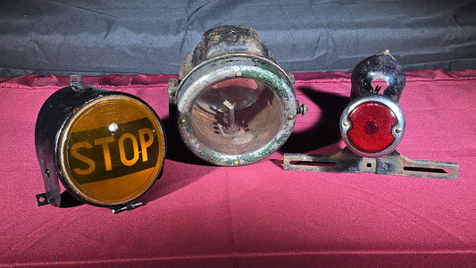 Grouping of Three Antique and Vintage Automotive Lights including Amber "STOP" Lamp, Headlamp, and Red Tail Light with License Plate Bracket