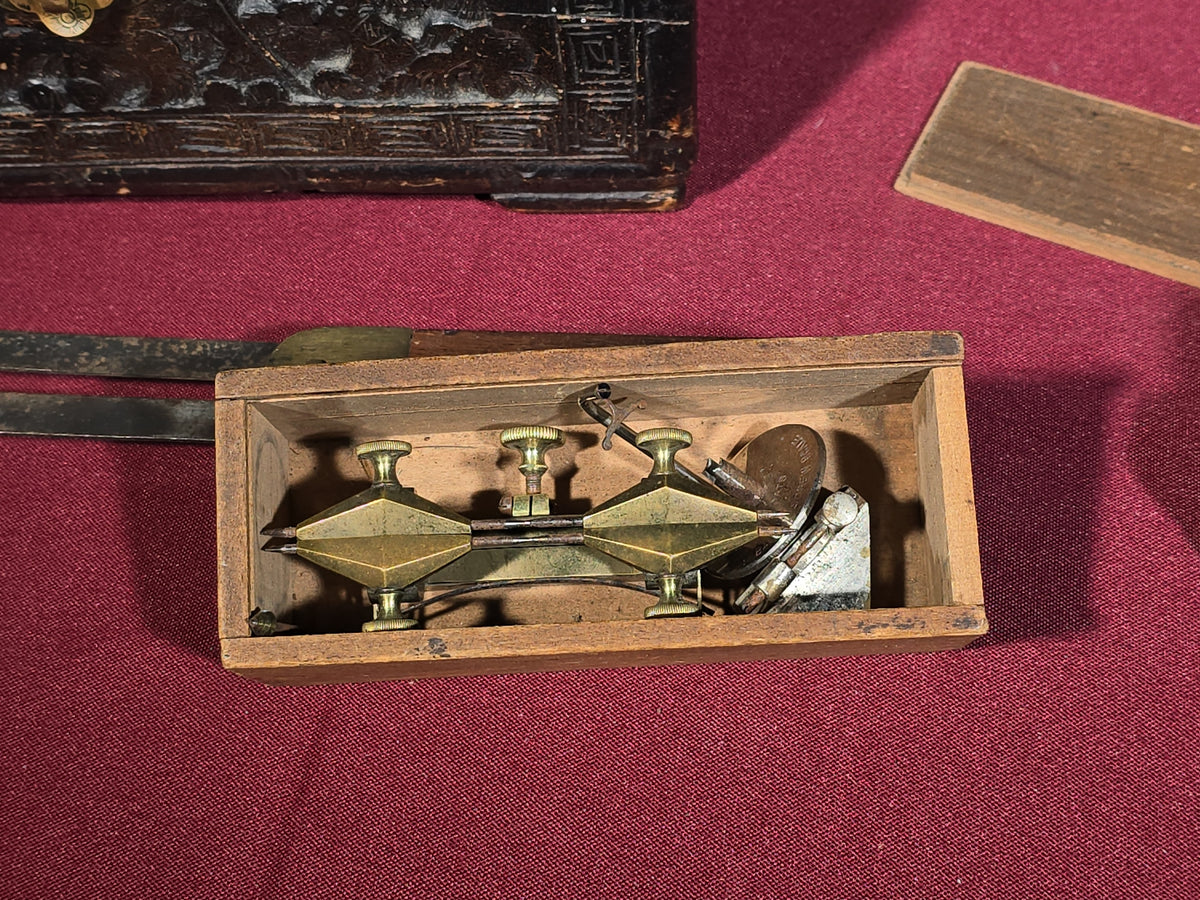 Grouping of Antique and Vintage Wooden Items including Carved Box, Wood Planes, Stirrups, and Brass Balance Scale