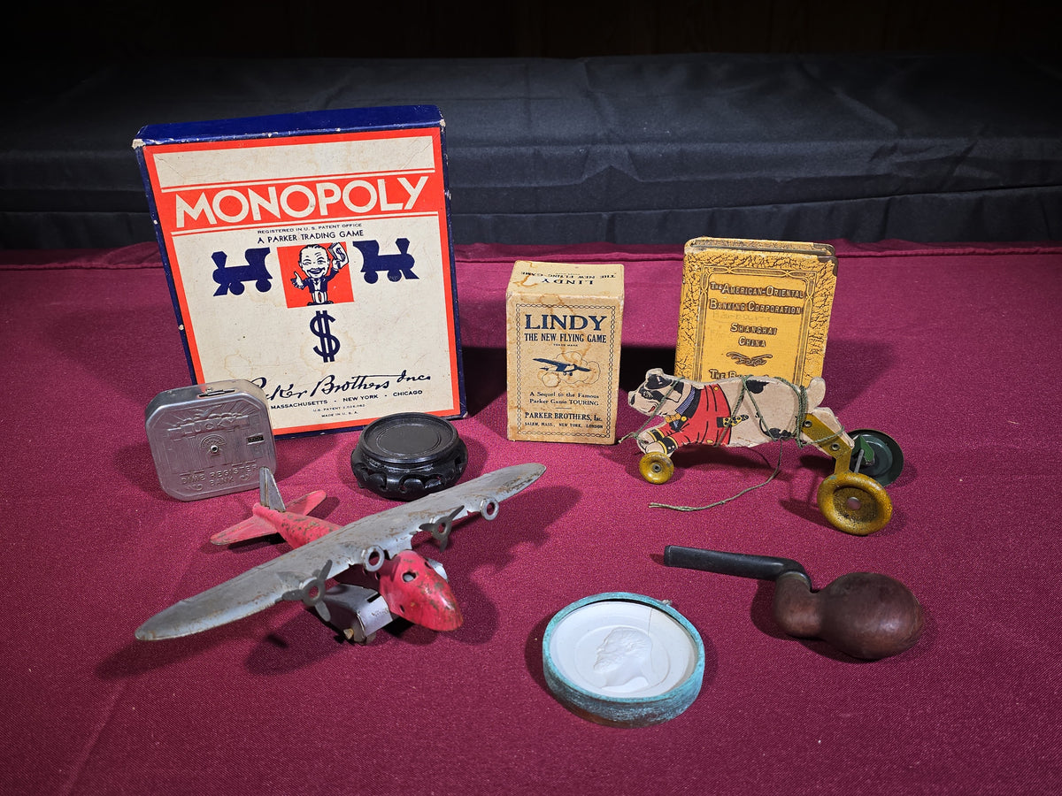Grouping of Antique and Vintage Toys and Collectibles including Monopoly Game, "Lindy" Flying Card Game, Metal Airplane, Wooden Pull Toy, and Dime Register Bank