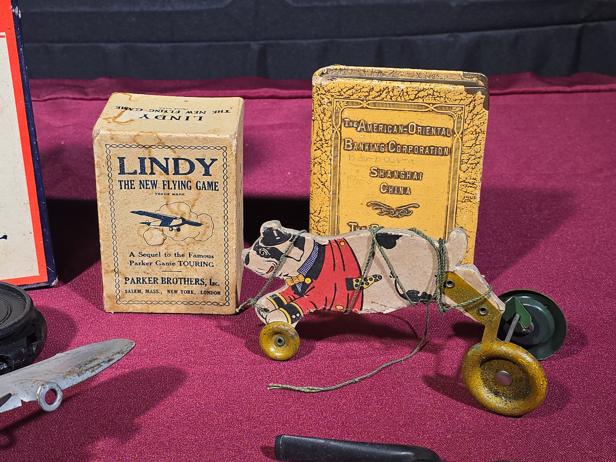 Grouping of Antique and Vintage Toys and Collectibles including Monopoly Game, "Lindy" Flying Card Game, Metal Airplane, Wooden Pull Toy, and Dime Register Bank