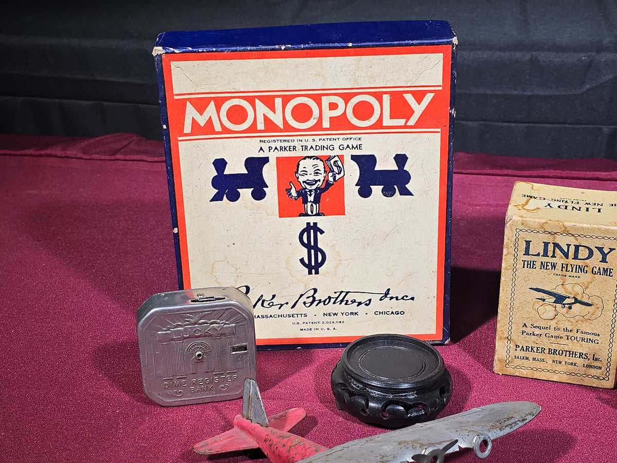 Grouping of Antique and Vintage Toys and Collectibles including Monopoly Game, "Lindy" Flying Card Game, Metal Airplane, Wooden Pull Toy, and Dime Register Bank