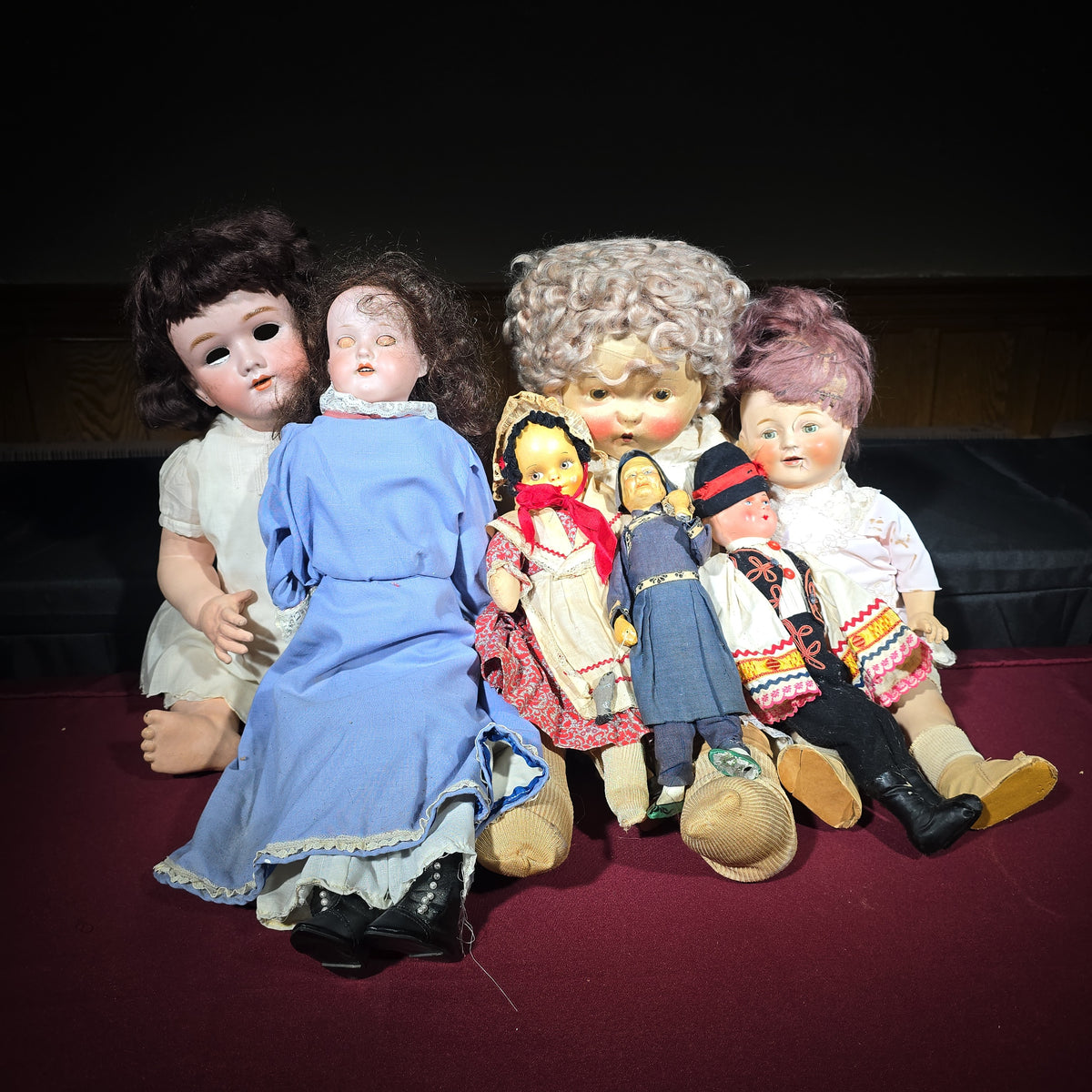 Grouping of Seven Antique and Vintage Dolls including Composition, Cloth, and Folk Costume Examples