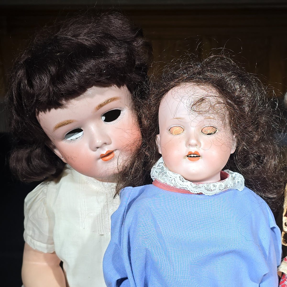 Grouping of Seven Antique and Vintage Dolls including Composition, Cloth, and Folk Costume Examples