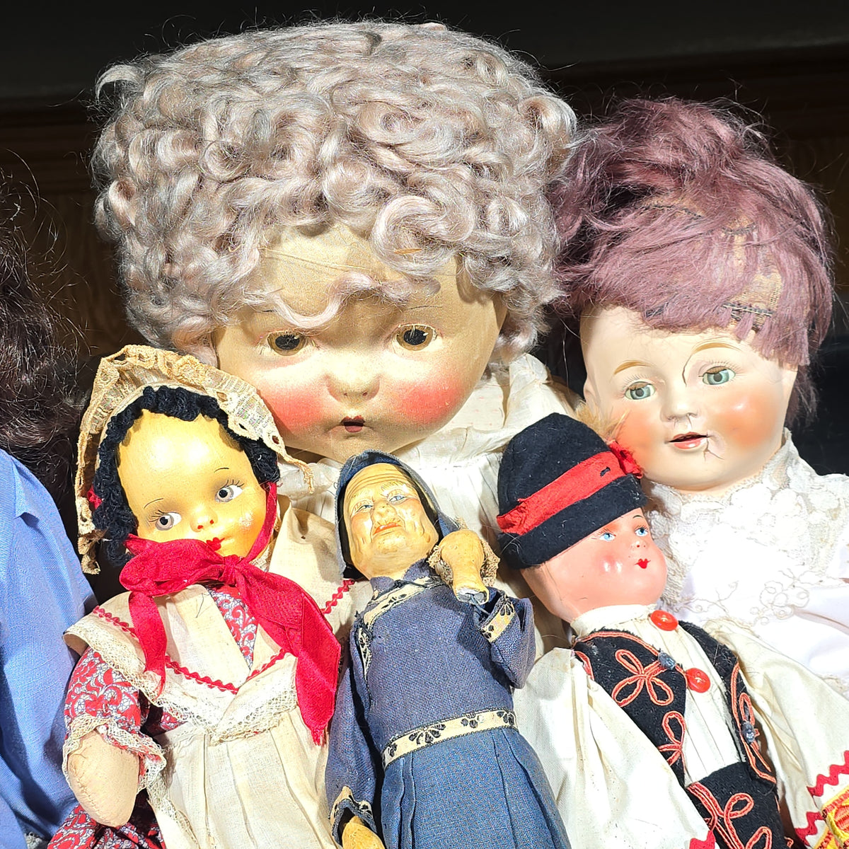 Grouping of Seven Antique and Vintage Dolls including Composition, Cloth, and Folk Costume Examples