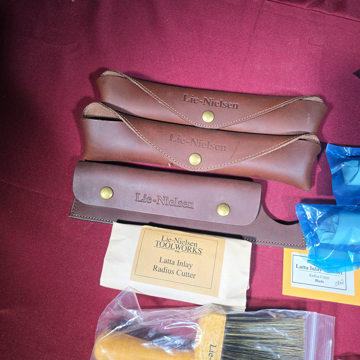 Grouping of Modern Brand New Lie-Nielsen Toolworks Tools including Latta Inlay Radius Cutter with Blades, Side Float Pull, Small Cheek Pull, Large Cheek Pull, Two Brushes, and Three Leather Cases