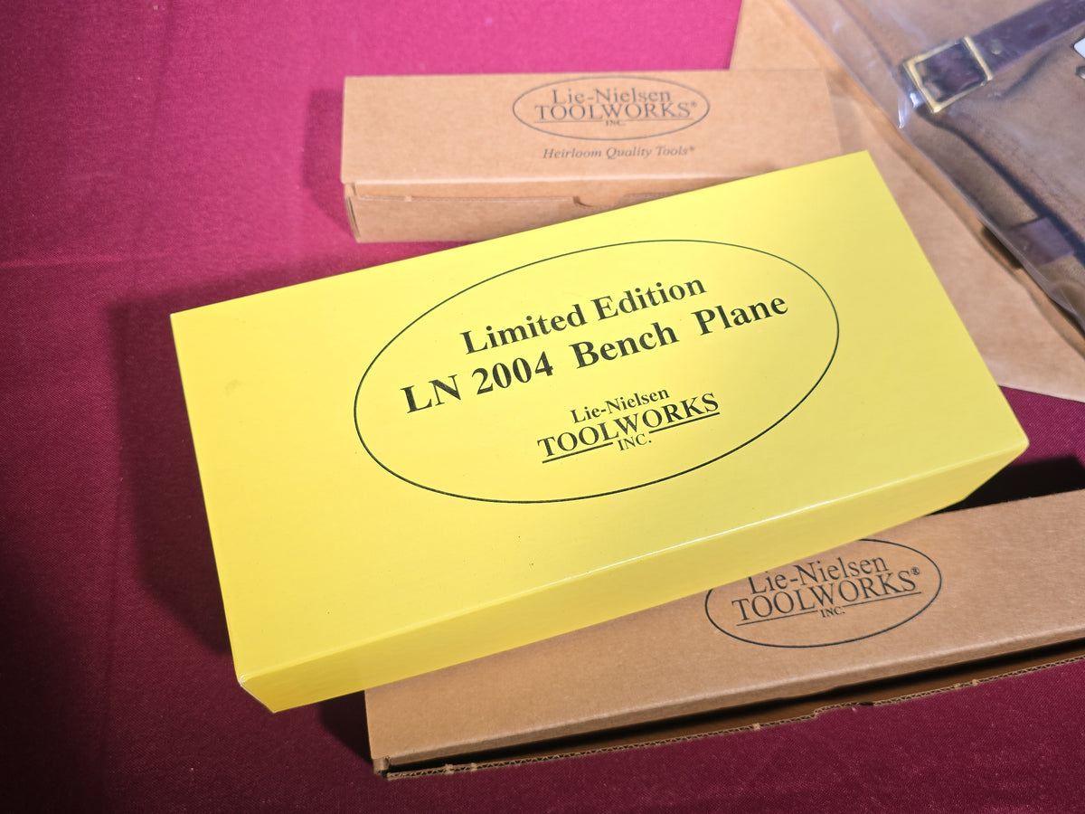 Grouping of Five Modern Brand New Lie-Nielsen Toolworks Tools and Accessories including Limited Edition LN 2004 Bench Plane, Small Bronze Spokeshaves, and Leather Carving Tool Roll, New in Boxes