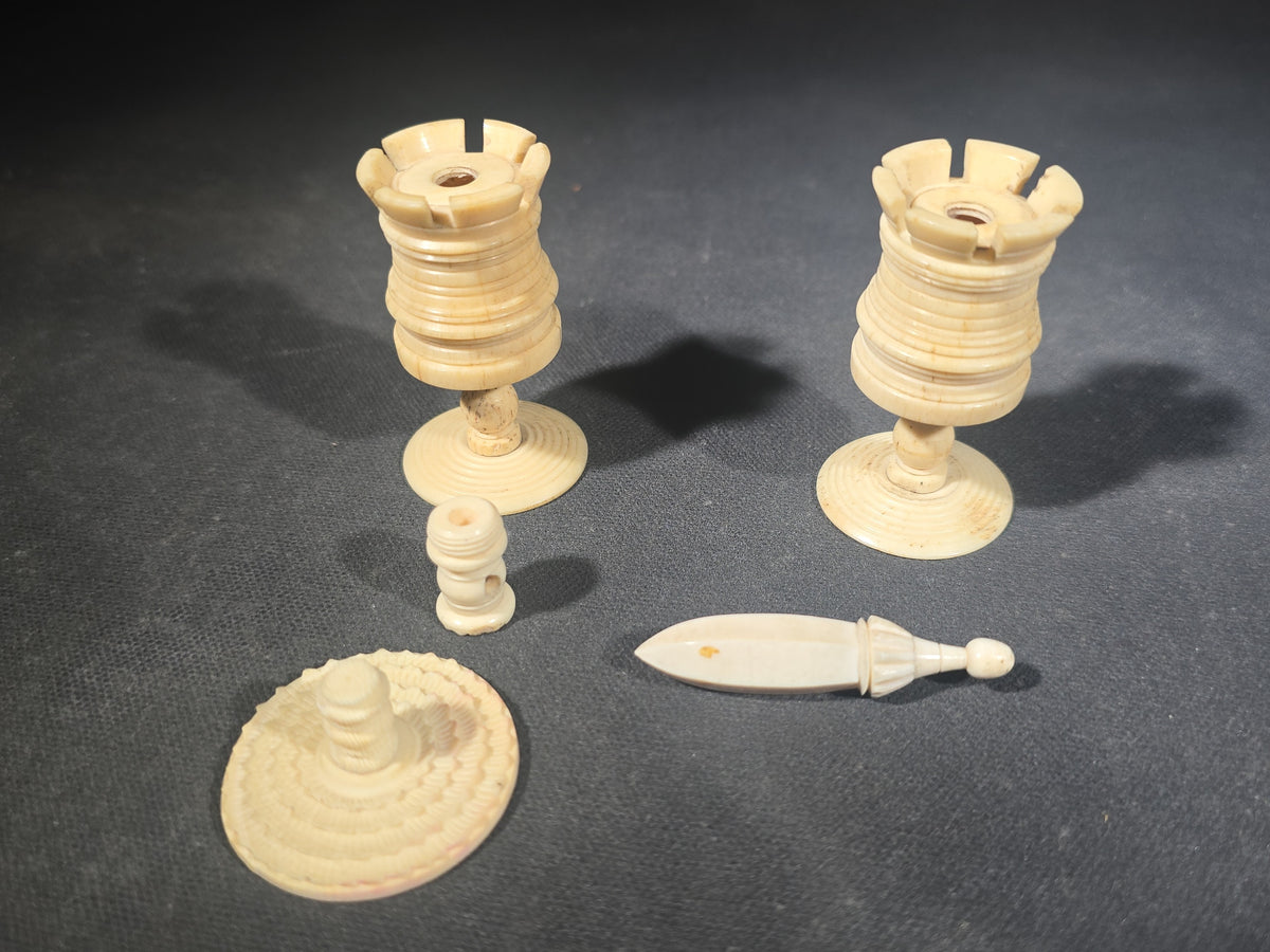 Grouping of Five Antique Carved Bone Pieces including Pair of Turned Rook Chess Pieces, Openwork Figural Panel, Turned Disc, and Turned Shuttle