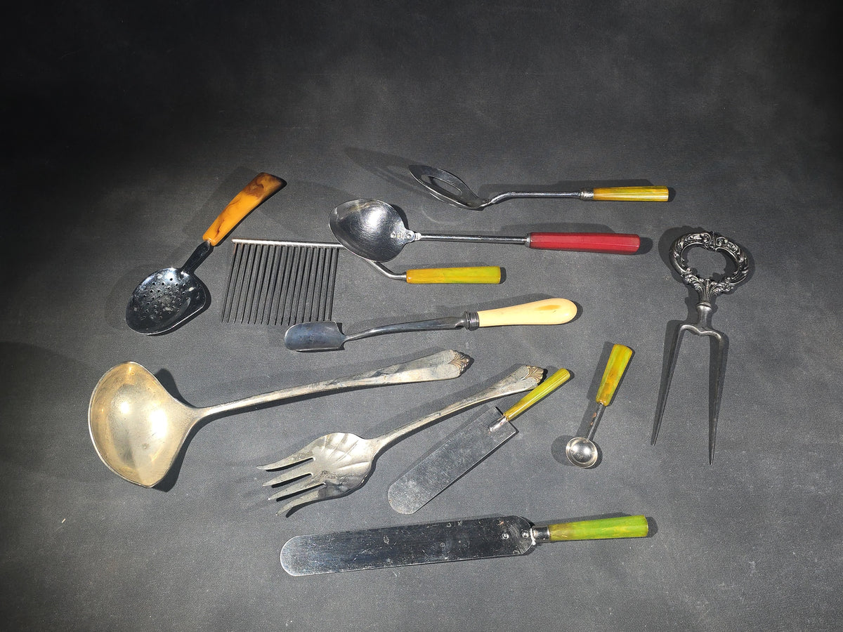 Grouping of Antique and Vintage Kitchen Utensils and Serving Pieces including Bakelite-Handled Flatware, Two-Tine Carving Fork, Ladle, and Crumb Comb