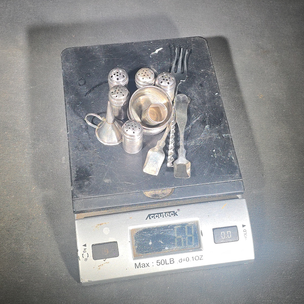 Grouping of 11 Sterling Silver Tableware Pieces including Individual Salt Shakers, Open Salt Cellars, Miniature Funnel, Sugar Tongs, and Cocktail Fork