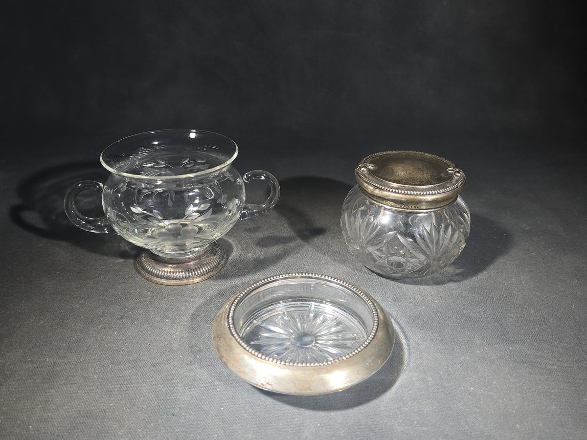 Grouping of Three Vintage Sterling Silver and Glass Tableware Pieces including Etched Two-Handled Sugar Bowl, Cut Glass Vanity Jar, and Glass Coaster