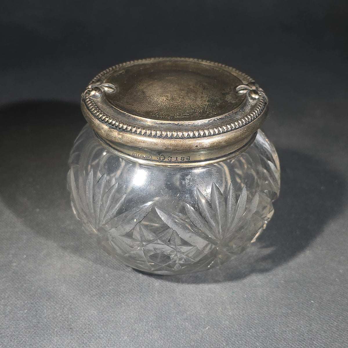 Grouping of Three Vintage Sterling Silver and Glass Tableware Pieces including Etched Two-Handled Sugar Bowl, Cut Glass Vanity Jar, and Glass Coaster