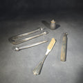 Lot 048 - Grouping of Five Antique and Vintage Sterling Silver and Silver-Plated Objects Including Sugar Tongs, Retractable Pencil, Sterling-Handled Toothbrush, Cylindrical Device, and Miniature Shaker, Total Weight 136 g