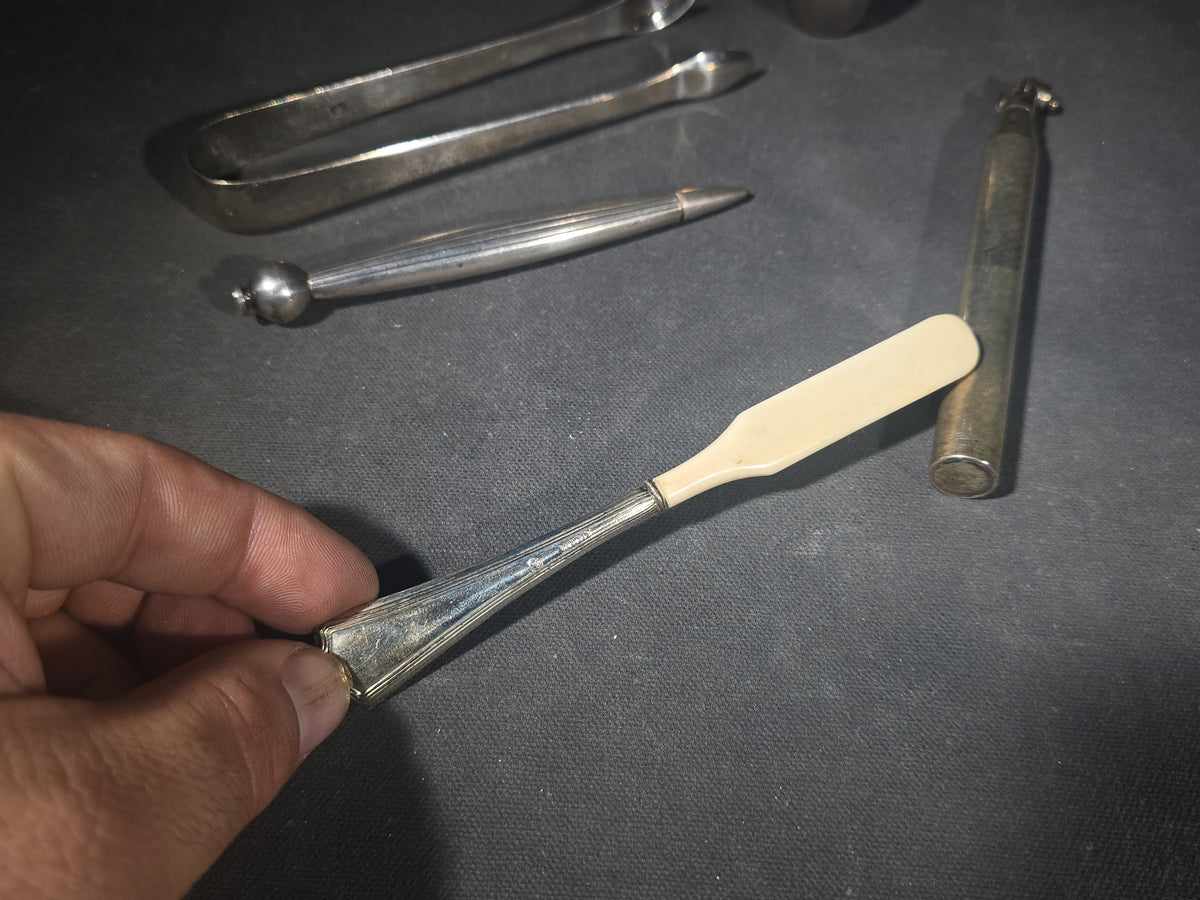 Grouping of Five Antique and Vintage Sterling Silver and Silver-Plated Objects including Sugar Tongs, Retractable Pencil, Sterling-Handled Toothbrush, Cylindrical Device, and Miniature Shaker