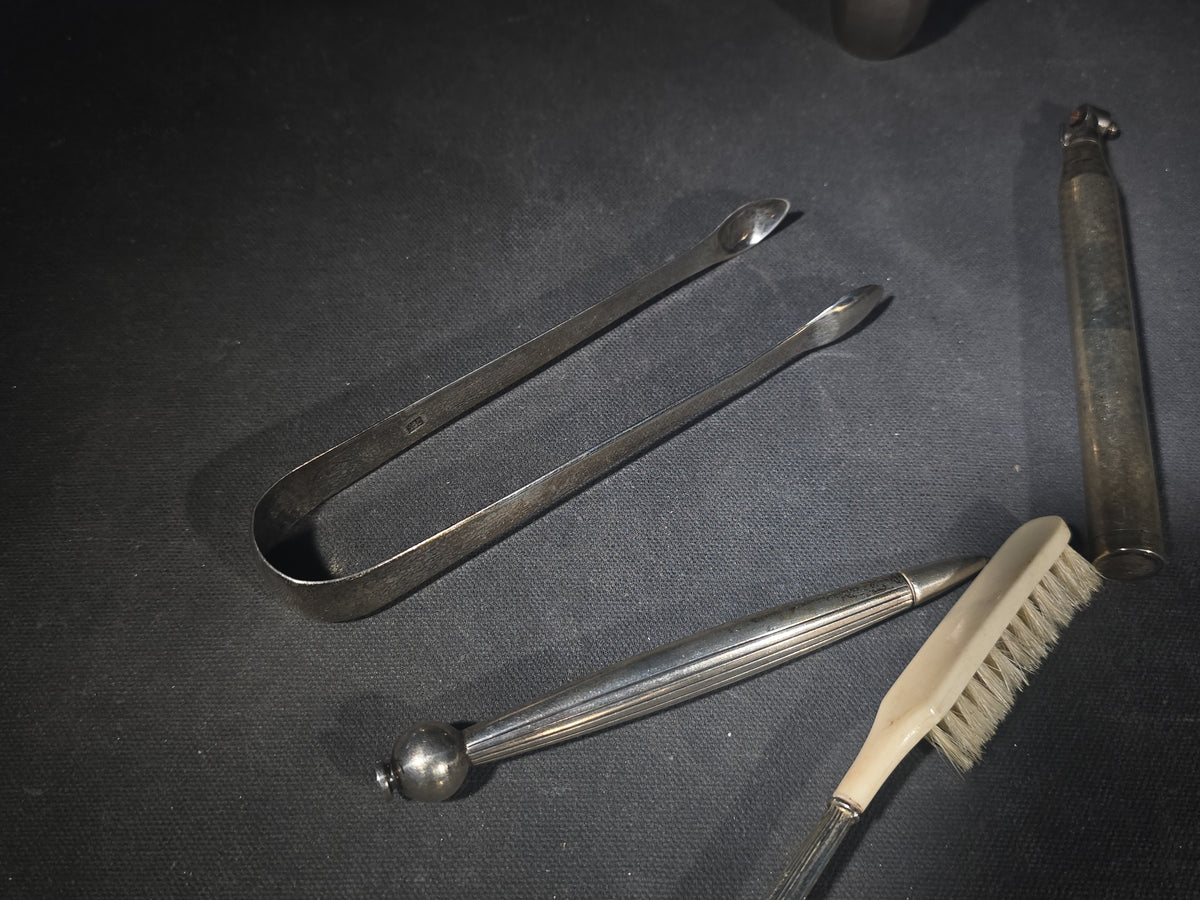 Grouping of Five Antique and Vintage Sterling Silver and Silver-Plated Objects including Sugar Tongs, Retractable Pencil, Sterling-Handled Toothbrush, Cylindrical Device, and Miniature Shaker