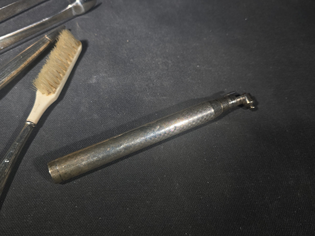 Grouping of Five Antique and Vintage Sterling Silver and Silver-Plated Objects including Sugar Tongs, Retractable Pencil, Sterling-Handled Toothbrush, Cylindrical Device, and Miniature Shaker