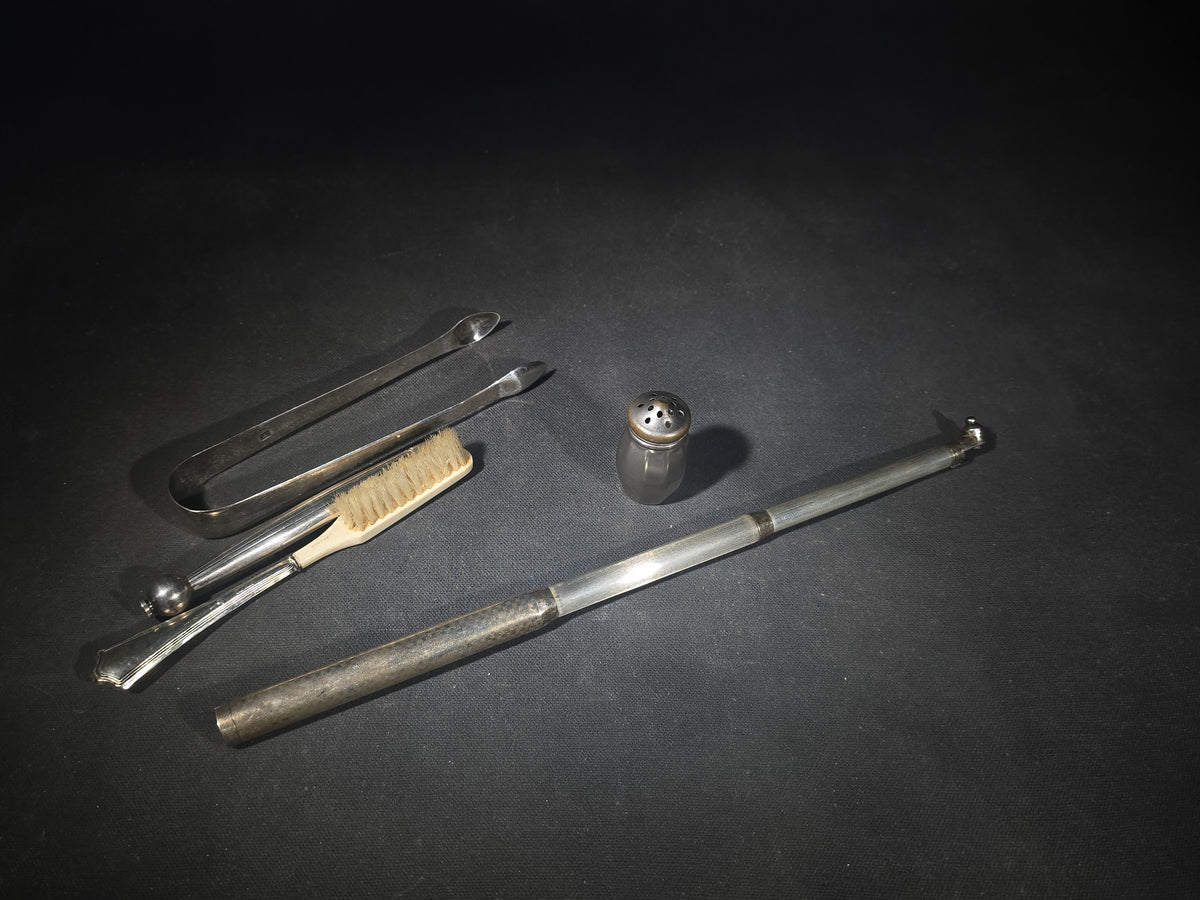 Grouping of Five Antique and Vintage Sterling Silver and Silver-Plated Objects including Sugar Tongs, Retractable Pencil, Sterling-Handled Toothbrush, Cylindrical Device, and Miniature Shaker