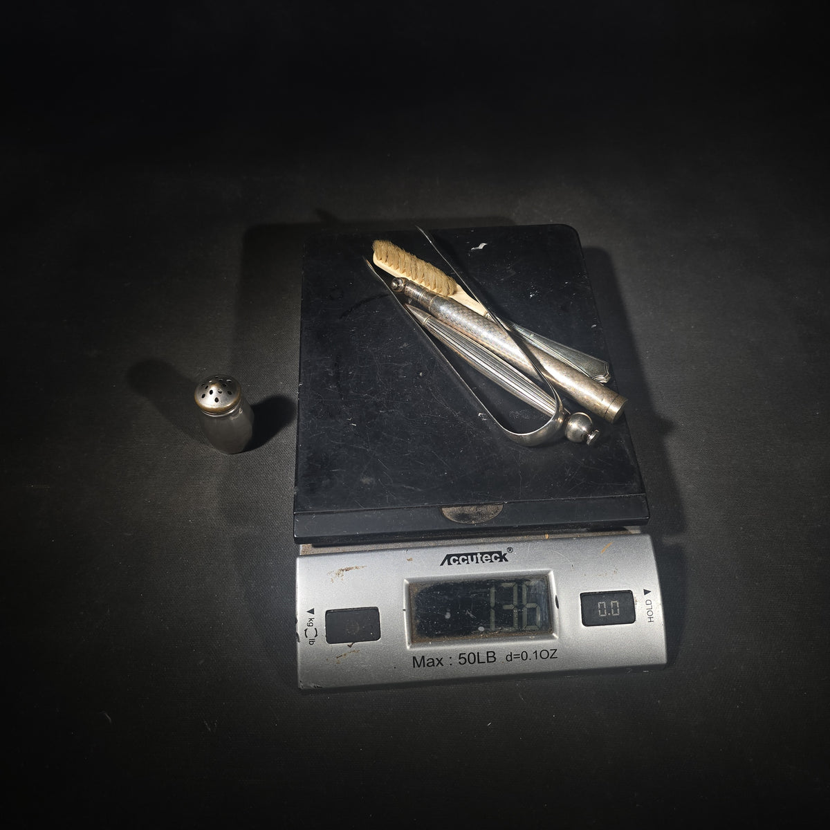 Grouping of Five Antique and Vintage Sterling Silver and Silver-Plated Objects including Sugar Tongs, Retractable Pencil, Sterling-Handled Toothbrush, Cylindrical Device, and Miniature Shaker