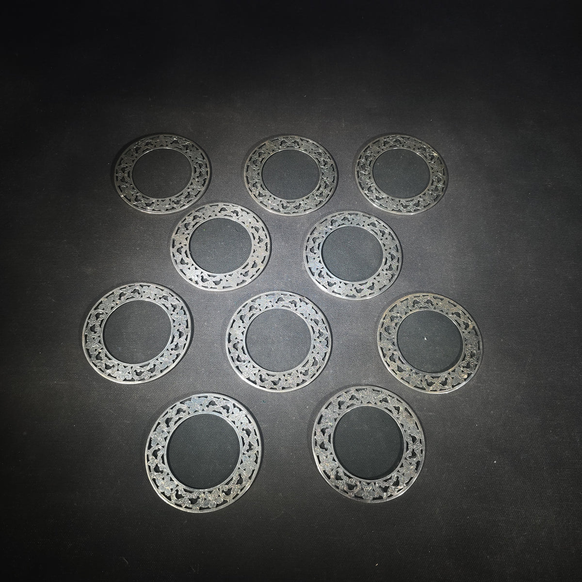 Grouping of 10 Sterling Silver and Glass Coasters with Pierced Floral Overlay
