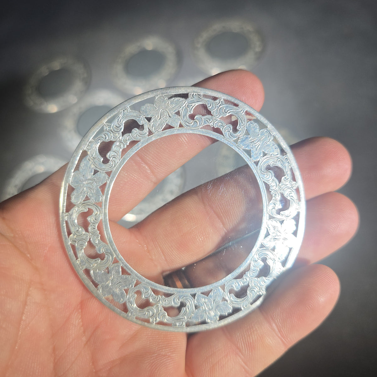 Grouping of 10 Sterling Silver and Glass Coasters with Pierced Floral Overlay