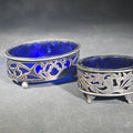 Lot 073 - Pair of Antique Sterling Silver Open Salt Cellars with Cobalt Blue Glass Liners and Pierced Baskets, Retailed by A. Stowell & Co. Inc., Monogrammed