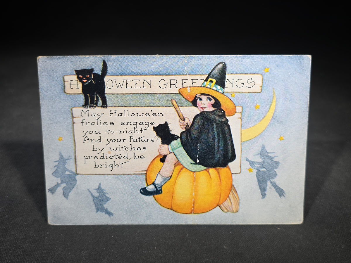 Antique Embossed "Hallowe'en Greetings" Postcard with Girl in Witch Costume Seated on Pumpkin, Black Cat, and Crescent Moon, Published by Whitney, Worcester, Massachusetts, Note Crease Down Center