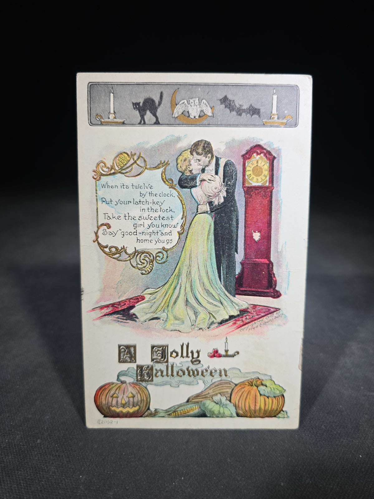 Antique Embossed "A Jolly Halloween" Postcard with Couple Embracing by Grandfather Clock, Black Cat, Bat, Owl, and Jack-O-Lantern, Postmarked Reading, Pennsylvania, 1907