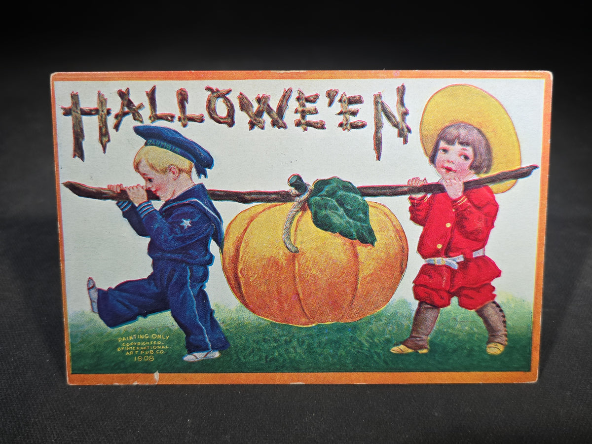 Antique Embossed "Hallowe'en" Postcard with Two Children Carrying Large Pumpkin on a Stick, Published by International Art Publishing Co., New York and Berlin, 1908, Postmarked Hinckley, Maine