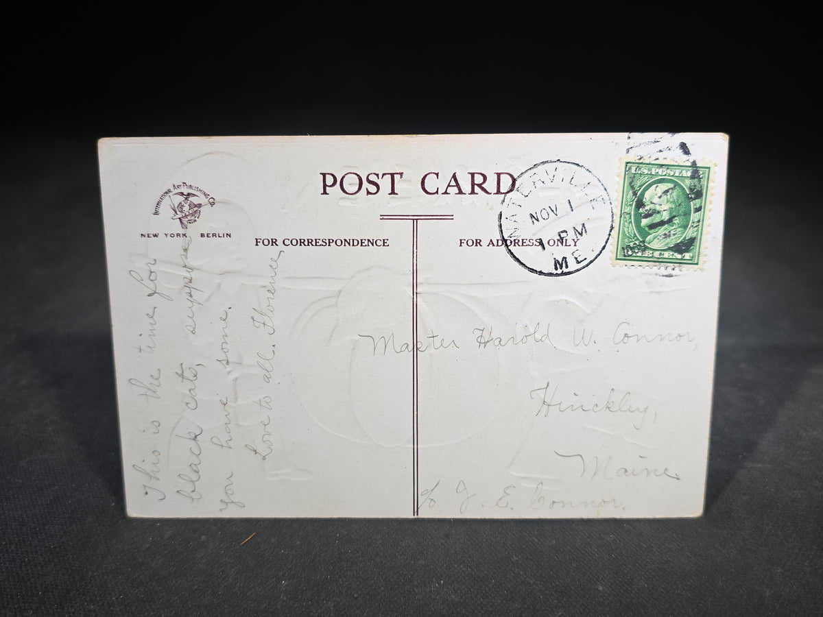 Antique Embossed "Hallowe'en" Postcard with Two Children Carrying Large Pumpkin on a Stick, Published by International Art Publishing Co., New York and Berlin, 1908, Postmarked Hinckley, Maine