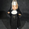 Lot 121 - Vintage Composition Nun Doll in Black Habit with Crucifix and Metal Display Stand