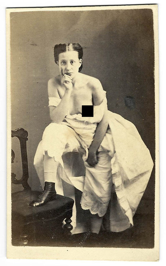 Antique Risque Carte de Visite C.D.V. Photograph of a Seated Young Woman with Exposed Breast, Draped in White Fabric with Foot Resting on a Chair