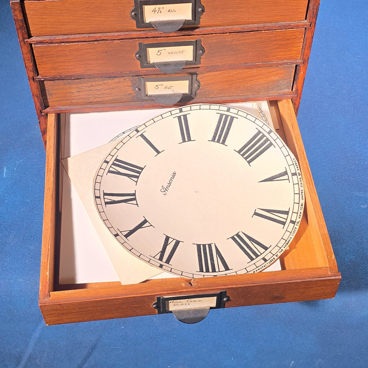 Vintage Oak Five-Drawer Cabinet with Clock Repair Paper Dial Faces including Ansonia, Sessions, and Ingraham